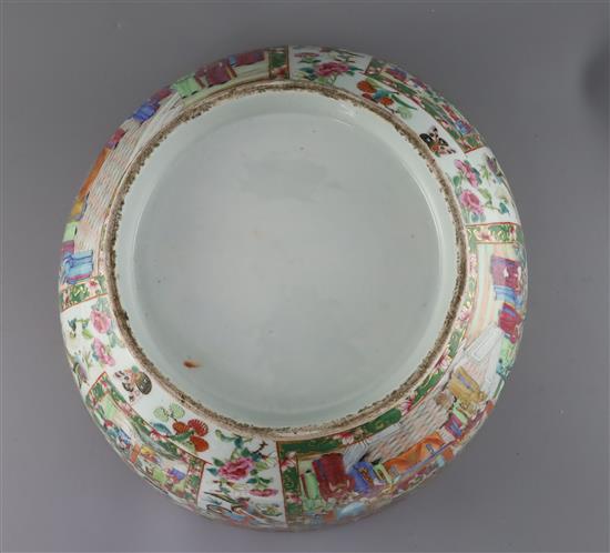 A large Chinese Canton-decorated famille rose punch bowl, c.1830, W.41.5cm, section broken and restuck, and two hairline cracks